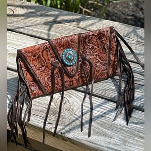 Western leather wrap clutch purse with fringe and concho